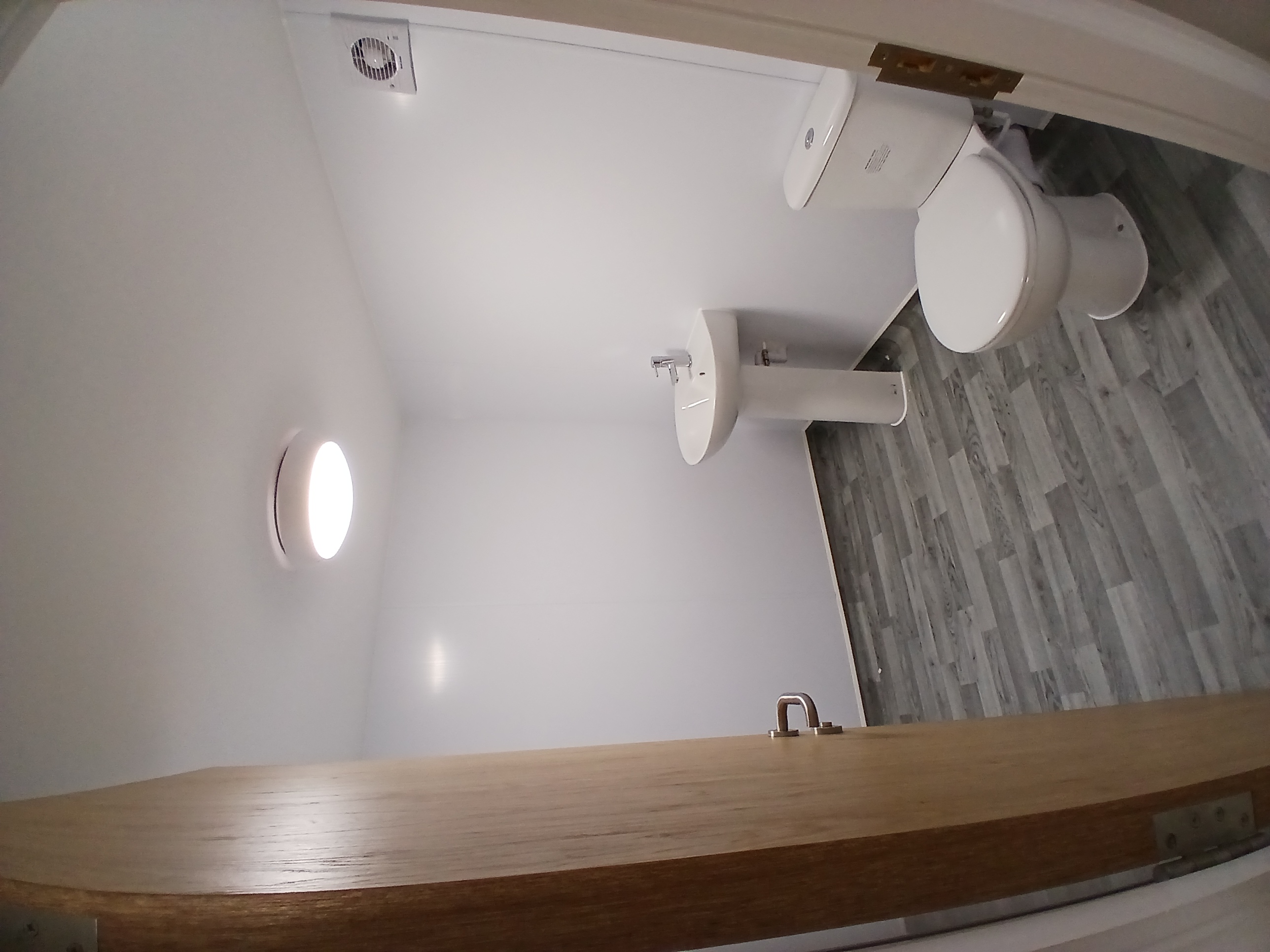 Newton Heath Bathroom Cladding - Hygienic wall cladding installation across two bathrooms and a storage area, finished with clean, durable and easy-to-maintain white panels